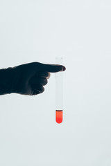 cropped shot of doctor holding glass test tube with blood isolated on white