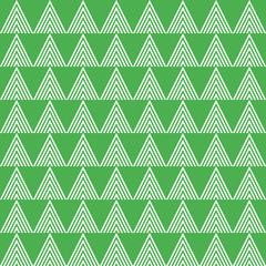 Seamless vector pattern with triangles on green background