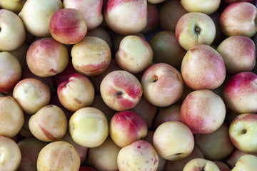 Pile of fresh orange and yellow apples top view close up.