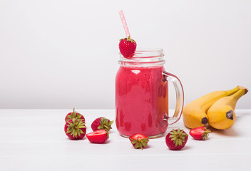 Strawberry and banana smoothie on the white background.