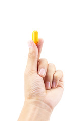 Fish oil capsule in hold hand isolated on white background