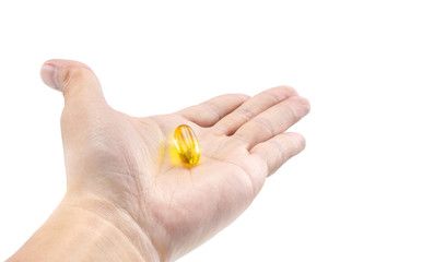 Fish oil capsule on hold hand isolated on white background