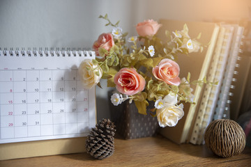 Fototapeta na wymiar Desktop Calendar page 2018 place on a wooden office desk.Calender and notebook for Planer timetable,agenda appointment,organization,management each date,month and year.Calendar Concept.