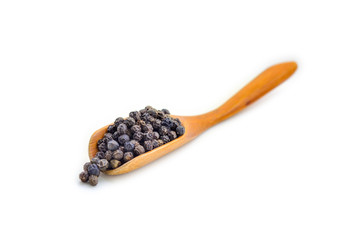 Black pepper on wooden spoon isolated on white background