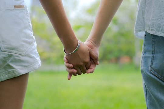 Couples holding hands in beautiful park
