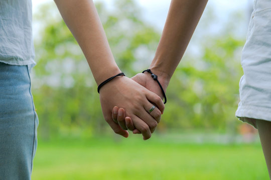Couples holding hands in beautiful park