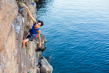 girl climber climbs up.