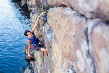 girl climber climbs up.