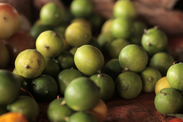 food macro background- many yellow and green limes outdoors on a sunny day in Africa