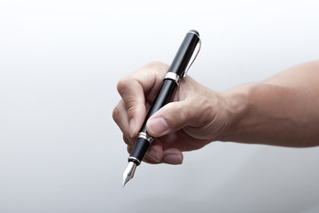  A hand holding a fountain pen