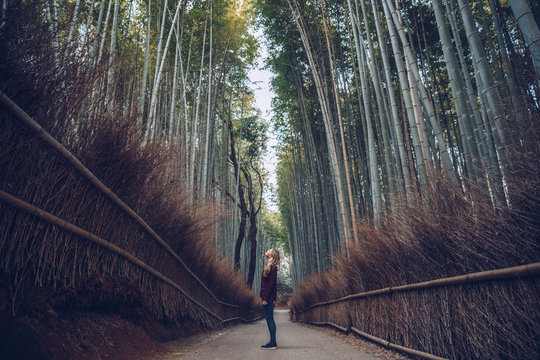 Woman walking alone in the Arashiyama Bamboo Forest