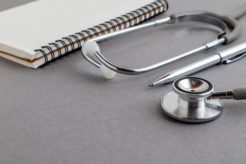 Medical equipments including stethoscope, prescription medicines background, top view flat lay