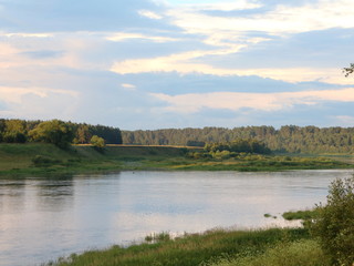 picturesque banks of the river in the summer evening