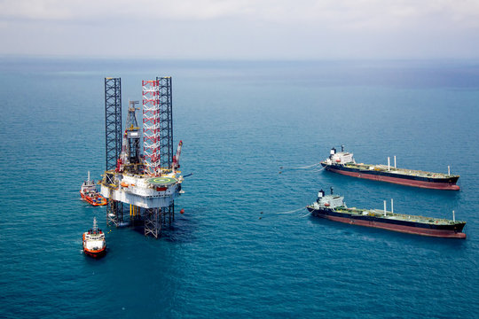 Oil rig in the gulf with oil tanker ship