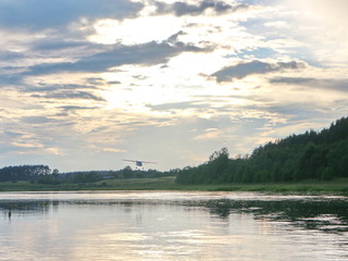 Obraz na płótnie Canvas evening clouds on the river after sunset