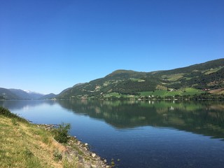 Fototapeta na wymiar Lake with small village near Trollstigen, Norway