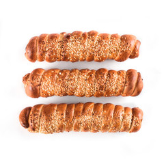 Sausages in dough with sesame, top view over white background, isolated