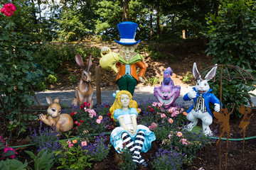 Colourful platic charackters of Alice in Wonderland against green background