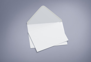 Opened envelope with blank card. Blank envelope with post card on dark background.