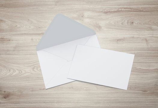 Opened envelope with blank card. Blank envelope with post card on dark background.