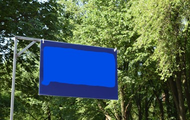 blue sign in shape of Connecticut against trees