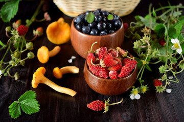 Strawberries, blueberries and chanterelles. Freshly picked forest berries and mushrooms