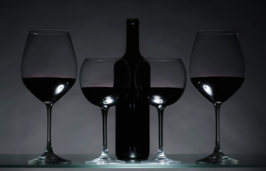 Glasses and bottle of red wine.
