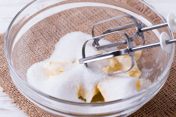 Mixing butter and sugar in bowl with mixing machine