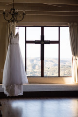 A wedding dress hanging in the chapel before the ceremony