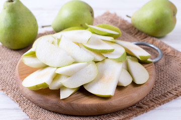 Cut pears on wooden board