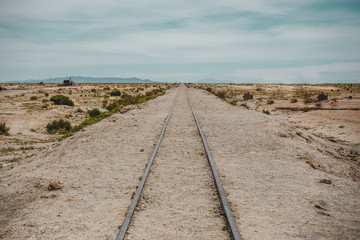 Train track goes off into the distance in the desert of Bolivia