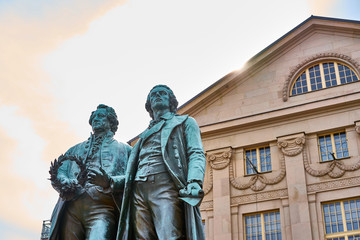 Fototapeta na wymiar Famous sculpture of Goethe and Schiller in the city of Weimar in Germany / Most famous classical german authors / 18th century