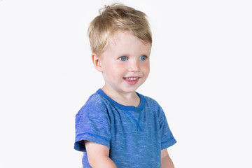 Three years old kid and emotions, close-up portrait of happy smiling child looking at camera at white background