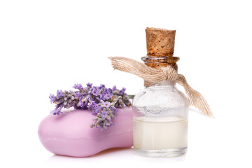 Obraz na płótnie Canvas Lavender oil in a glass vial with soap isolated on a white background