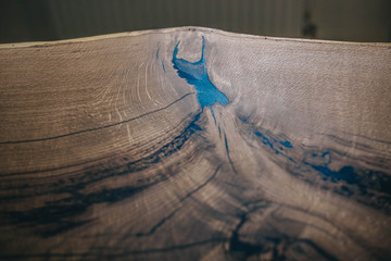 surface of the board of solid wood. Exclusive furniture made with tin and epoxy.