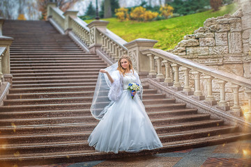 Plakat Beautiful bride with bouquet of flowers on background of stone staircase 