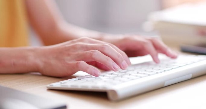Woman typing on computer keyboard