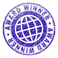 AWARD WINNER stamp imprint with distress effect. Blue vector rubber seal imprint of AWARD WINNER label with unclean texture. Seal has words arranged by circle and globe symbol.