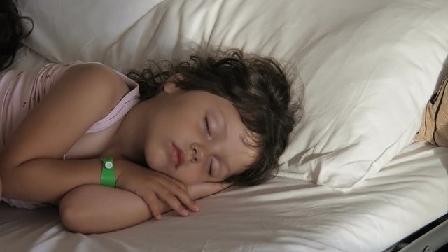 Portrait of a sleeping child. A little girl is sleeping in soap bubbles.