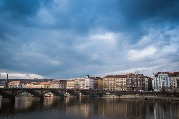 Palacky bridge over Vltava river in Prague, Czech Republic. Buildings and cloudy sky in the background. Space in the top side
