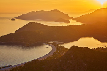 Oludeniz beach and small town of Oludeniz, view from mountain at sunset.