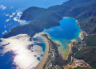 Amazing aerial view of Blue Lagoon in Oludeniz, Turkey. Summer landscape with sea spit, green trees, azure water, sandy beach in bright sunny day.