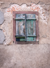 Distressed shutters in the Alsace village of Turkheim, France