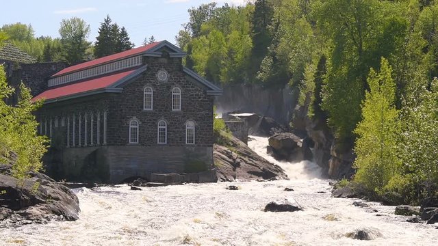 La Pulperie de Chicoutimi Regional Museum Pulp mill in Saguenay, Quebec, Canada with river and water current flowing in summer