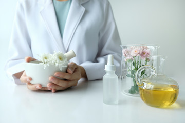 the scientist,dermatologist testing the organic natural product in the laboratory.research and development beauty skincare concept.blank package,bottle,container .cream,serum.