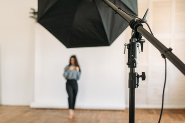 Model poses in photo studio, white background