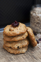 Homemade oatmeal cookies on wooden board and black background, with dry fruits. Sweet dessert snack, Healthy Food. Copy space. Banner.