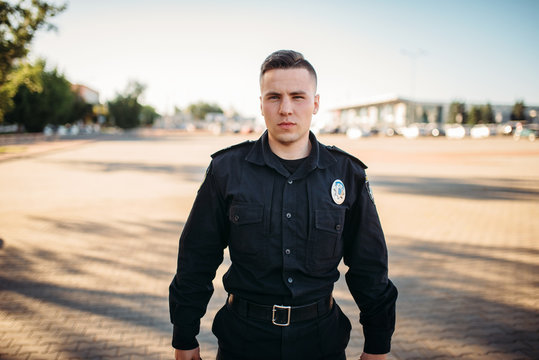 Male Police Officer In Uniform On The Road