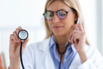 Female doctor working with laptop and researching some medication information in the consultation.