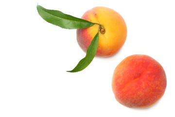 peach fruit with green leaf isolated on white background. top view